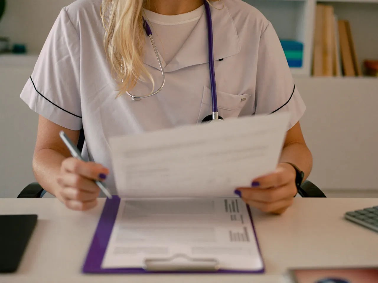 hero — therapist at a desk reviewing an insurance panel list